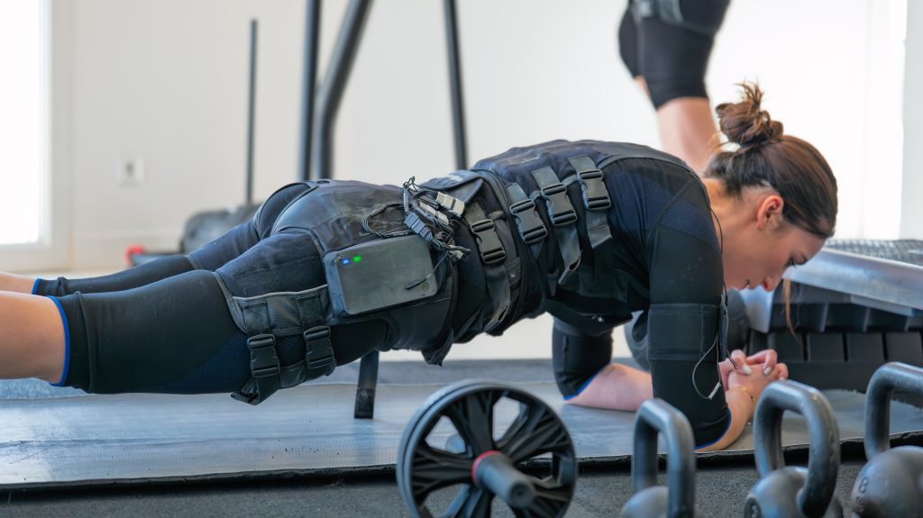 Gainage au sol en combinaison EMS au studio Fit'Elec